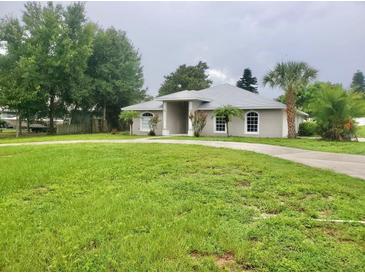 Single story home with large front yard and circular driveway at 1025 W Lake Hamilton Dr, Winter Haven, FL 33881