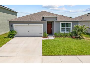 One-story home with two-car garage and manicured lawn at 2807 Harmonia Hammock Rd, Harmony, FL 34773