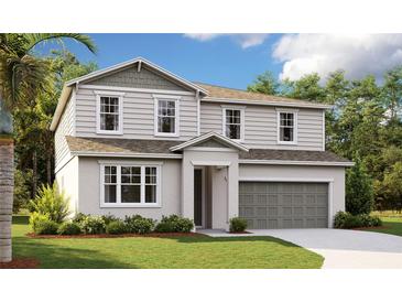 Two-story home with gray siding and a two car garage at 310 Alexandrite St, Deland, FL 32720