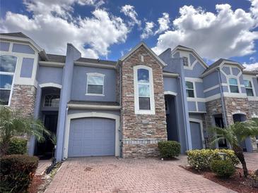 Exterior view of charming townhome with stone accents at 2106 Chatham Place Dr, Orlando, FL 32824