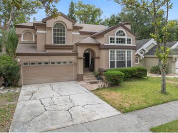 Two-story house with a two-car garage and manicured lawn at 2971 Cayman Way, Orlando, FL 32812