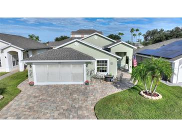 House exterior with a screened garage and landscaped yard at 117 Ridge View Dr, Davenport, FL 33837