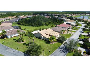 Single-Gathering home with tile roof, manicured lawn, and palm trees at 203 Escondido Ct, Poinciana, FL 34759