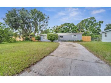 Newly renovated home with gray exterior and driveway at 1318 Terre Cia Ave, Orlando, FL 32807