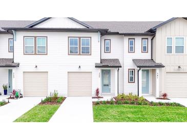 Newly built townhouses with attached garages at 718 Longboat Dr, Davenport, FL 33896