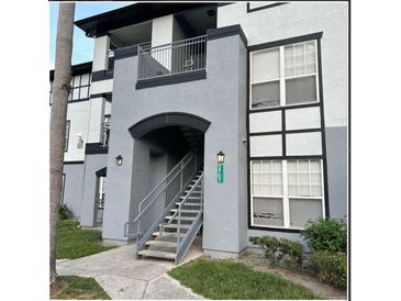 Exterior view of a two-story building with stairs and landscaping at 3701 Castle Pines Ln # 3914, Orlando, FL 32839