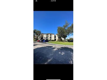 Exterior view of an apartment building with parking at 1916 Lake Atriums Cir # 46, Orlando, FL 32839