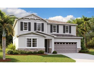 Two-story home with gray siding, stone accents, and a two-car garage at 1401 Levy Bend Dr, Kissimmee, FL 34744