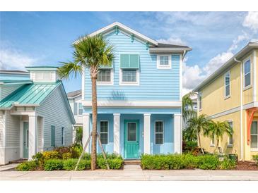 Charming light blue two-story home with teal door and palm tree at 3037 Sea Plane Ln, Kissimmee, FL 34747