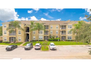 Apartment building with ample parking and landscaped grounds at 2300 Silver Palm Dr # 303, Kissimmee, FL 34747