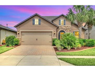 Beautiful two-story house with a large driveway and landscaped yard at 356 Toldedo Rd, Davenport, FL 33837