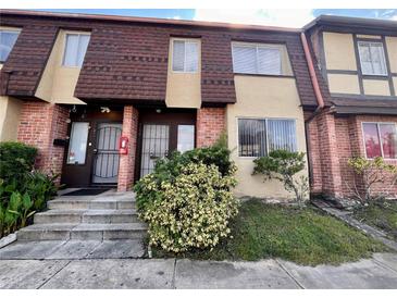 Brick townhouse with brown roof and landscaping at 5150 Picadilly Circus Ct # 7, Orlando, FL 32839