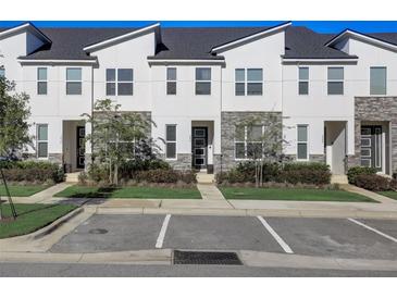 Modern townhouses with stone accents and neatly landscaped yards at 1842 Tropical Palms Cir, Kissimmee, FL 34747