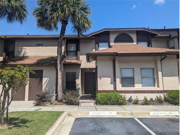 Condo building exterior with walkway and landscaping at 2912 S Semoran Blvd # 9, Orlando, FL 32822