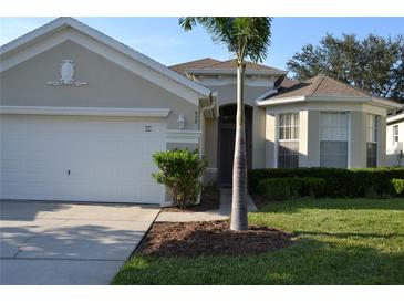 One-story house with two car garage and palm tree at 608 Copeland Dr, Haines City, FL 33844