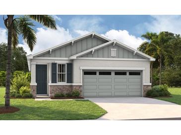 Two-story craftsman style home with a three car garage at 183 Bull Frog Ln, Umatilla, FL 32784