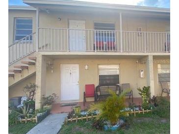 Tan two-story building with stairs and balcony at 725 Michigan Ct # 3, St Cloud, FL 34769