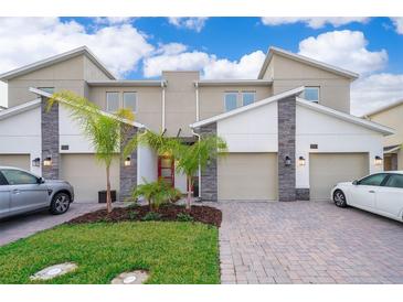 Modern townhome with two-car garage and landscaped front yard at 1157 Challenge Dr # 1157, Davenport, FL 33896