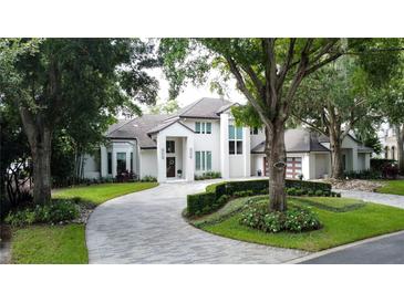 Stunning two-story home with a beautifully landscaped yard at 5126 Fairway Oaks Dr, Windermere, FL 34786