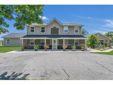 Two-story home with screened porch and landscaping at 3105 Pastures Rd, Kissimmee, FL 34746