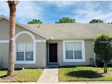 Front view of charming condo with mature landscaping at 2181 Cypress Bay Blvd, Kissimmee, FL 34743