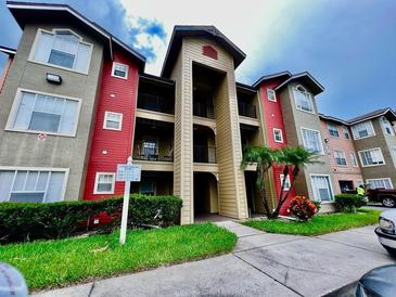 Attractive 3-story building with red and gray accents at 2210 Grand Cayman Ct # 1722, Kissimmee, FL 34741