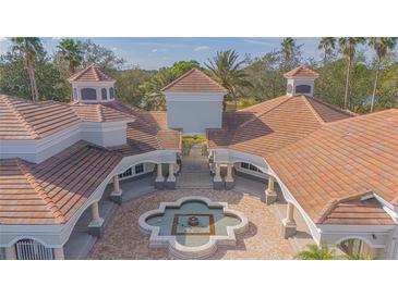 Aerial view of a grand estate with a courtyard and fountain at 14036 Fairway Island Dr # 1515, Orlando, FL 32837