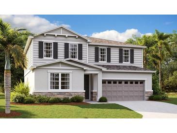 Two-story home with gray siding and stone at 4211 Sawtooth Ct, Tavares, FL 32778