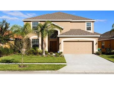 Two-story house with a large driveway and landscaping at 2505 Dharma Cir, Kissimmee, FL 34746