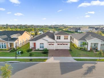 Two-story house in a community with a pond at 2692 Meadowedge Loop, Saint Cloud, FL 34772