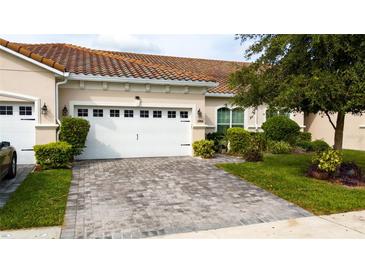 Exterior features a charming villa with a well-maintained lawn at 2804 Plymouth Pl, Kissimmee, FL 34741