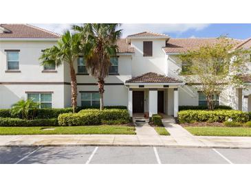 Two-story townhome with landscaping and parking at 8932 Stinger Dr, Davenport, FL 33896