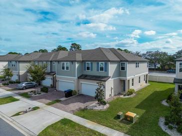 Two-story townhome with attached garage and manicured lawn at 15109 Willow Arbor Cir, Orlando, FL 32824
