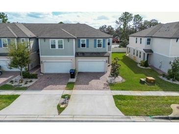 Two-story townhome with attached garage and landscaped yard at 15109 Willow Arbor Cir, Orlando, FL 32824