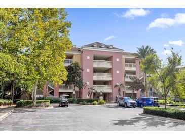 Three-story apartment building with parking and landscaping at 7650 Whisper Way # 203, Reunion, FL 34747