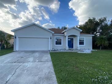 Two-story house with a two-car garage and landscaping at 3077 Brenton Manor Loop, Winter Haven, FL 33881
