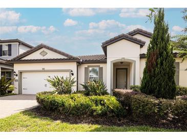 Single-story home with a two-car garage and landscaped yard at 7845 Wandering Way, Orlando, FL 32836
