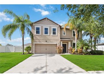 Two-story house with a two-car garage and landscaped lawn at 3804 Marietta Way, St Cloud, FL 34772