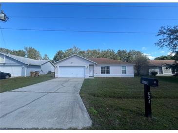 Cute one-story home with a large driveway and well-maintained lawn at 824 San Pedro Ct, Kissimmee, FL 34758