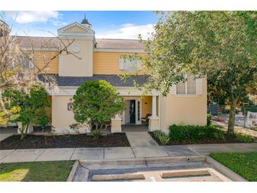 Inviting two-story townhome with a charming front porch and well-manicured landscaping at 7510 Seven Eagles Way # 7510, Reunion, FL 34747