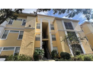 Visconti condo building, featuring a light yellow exterior and lush landscaping at 1150 Lake Shadow Cir # 3304, Maitland, FL 32751