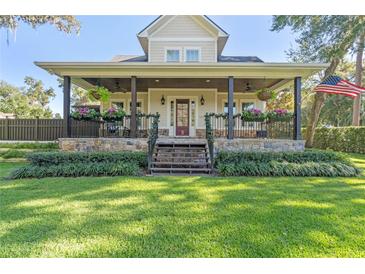 Two-story house with a large front porch, stone accents, and a well-manicured lawn at 729 Main Street, Windermere, FL 34786