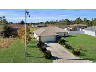 Single-story house with a driveway and landscaped yard at 12876 Sw 64Th Cir, Ocala, FL 34473
