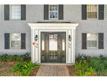 Gray brick building with black shutters and a central entrance at 163 Lewfield Cir, Winter Park, FL 32792