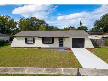 Newly renovated single story home with modern black accents and a freshly paved driveway at 460 Forest Ct, Altamonte Springs, FL 32714