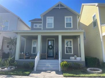 Charming two-story home with a welcoming front porch and landscaped yard at 13913 Hahn Ln, Orlando, FL 32827