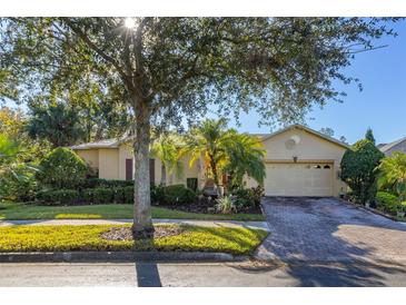 Attractive single-story home with a well-manicured lawn and paver driveway at 1287 Glendora Rd, Kissimmee, FL 34759