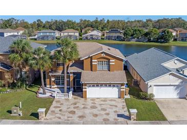 Two-story house with lake view, and a large backyard at 3209 Fairfield Dr, Kissimmee, FL 34743