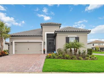 Beautiful one-story home with a two-car garage and landscaped yard at 1880 Goblet Cove St, Kissimmee, FL 34746