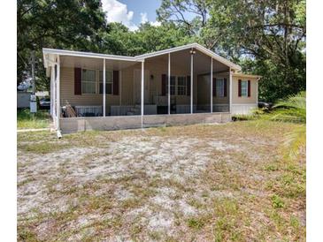 Mobile home with covered porch and large yard at 4914 Dove Ln, Auburndale, FL 33823